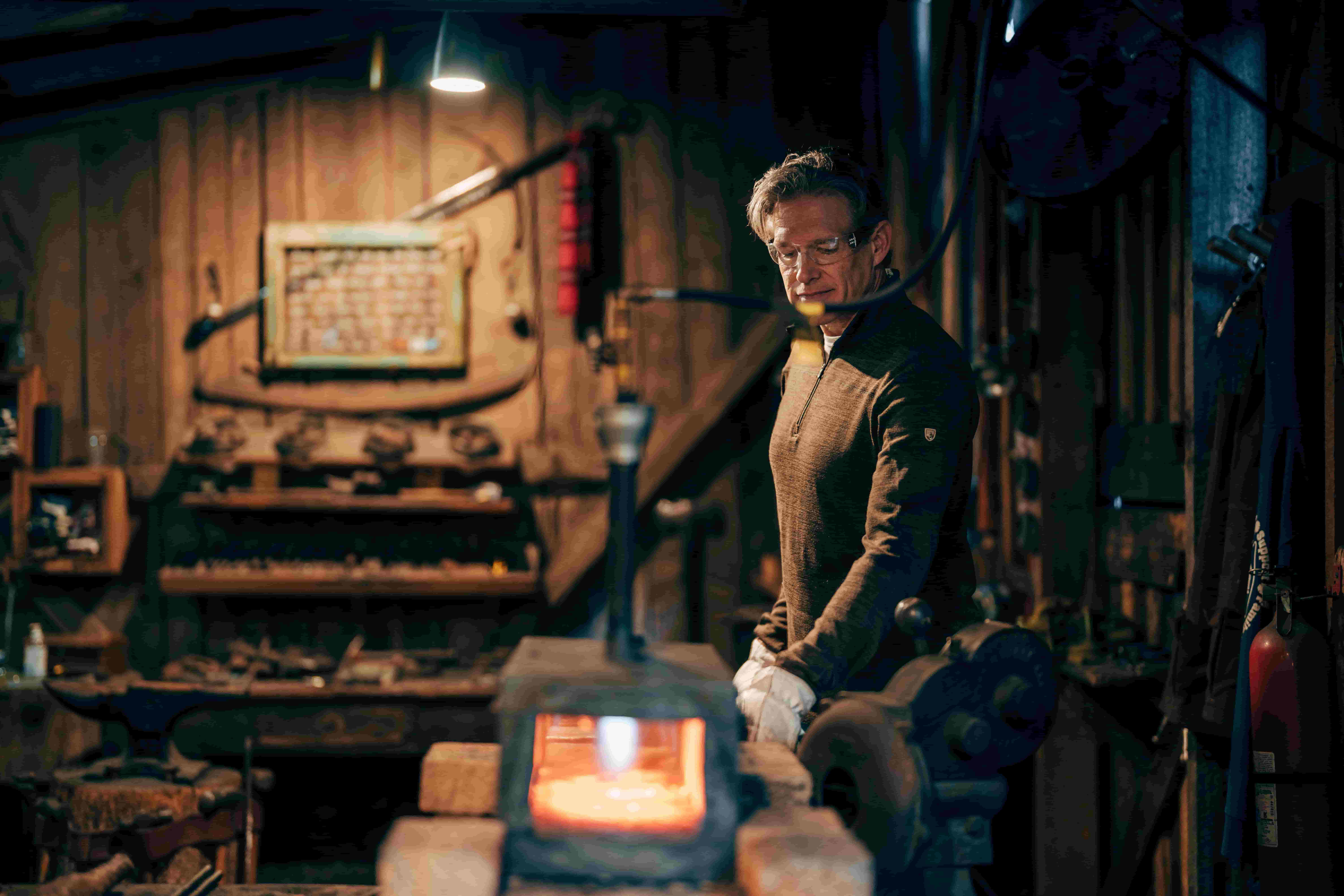Smith at forge with glowing steel