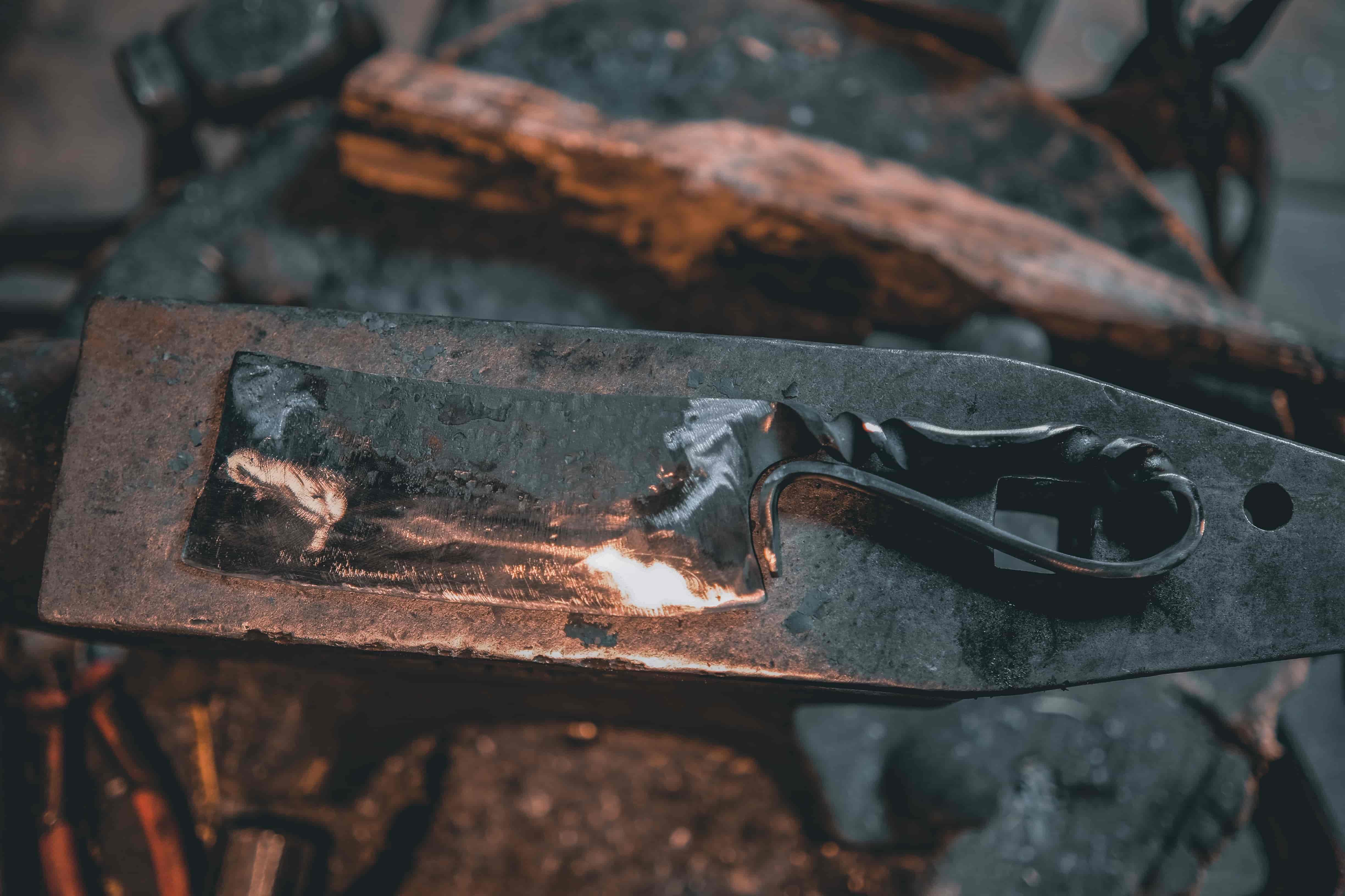 Woman hammering glowing blade